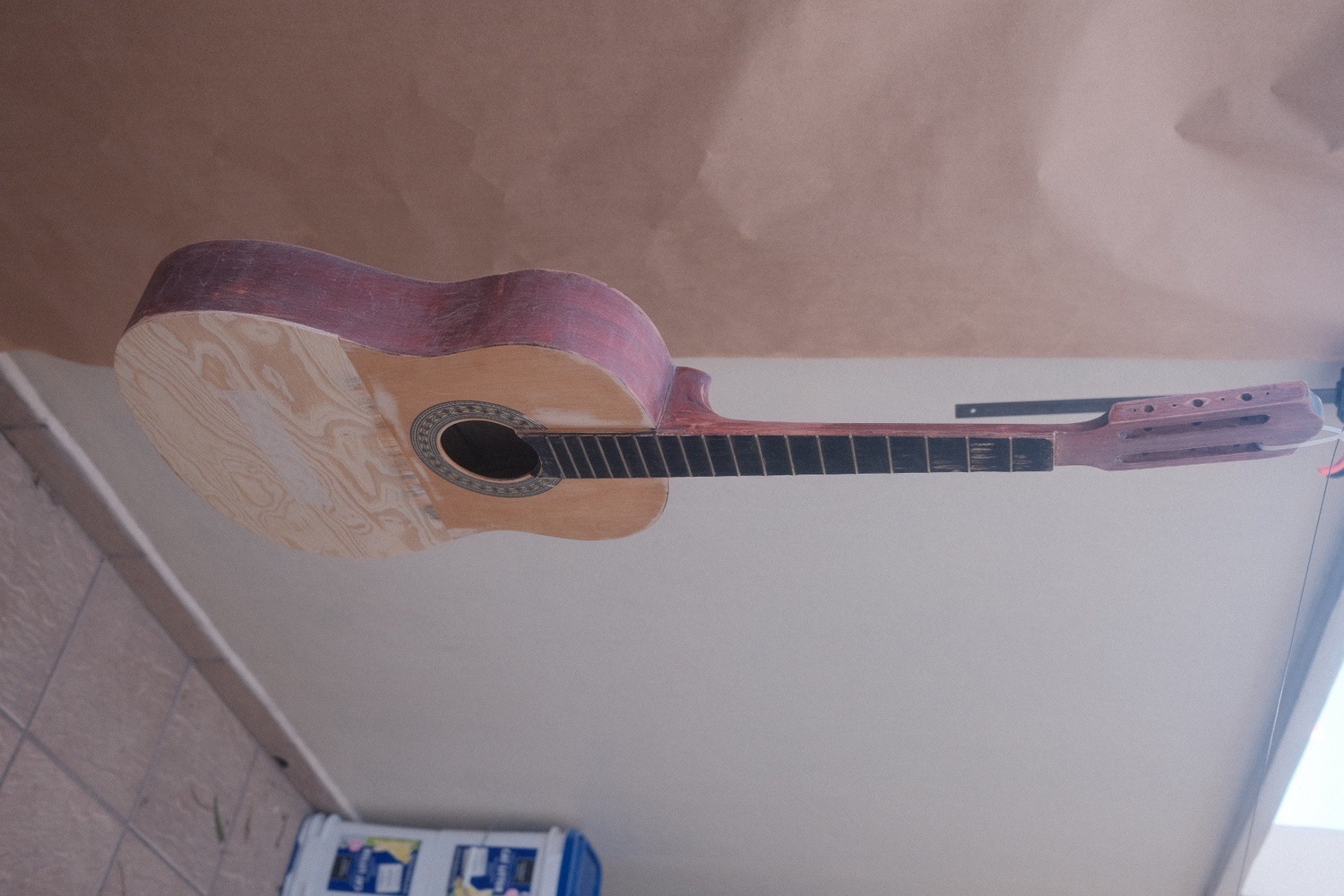 The guitar hanged from a wire to be painted