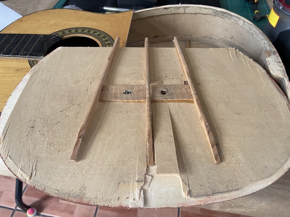 The lower half of the guitar's top removed from the guitar