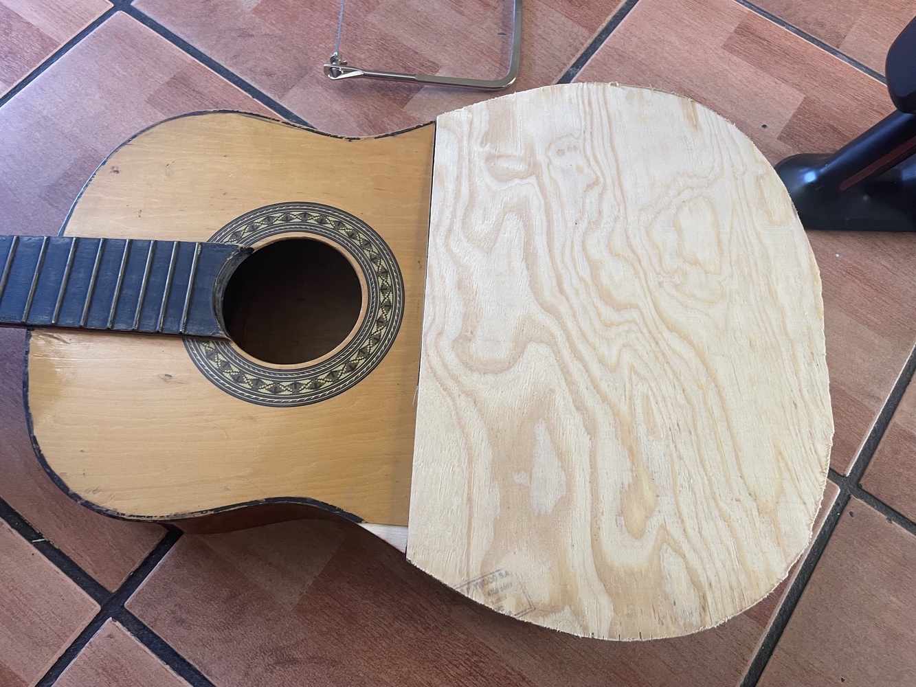 The guitar with it's new plywood top"
