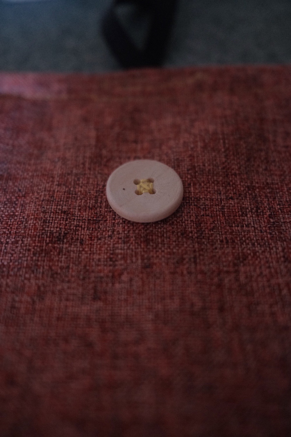 A closeup of the button sewn into place." 